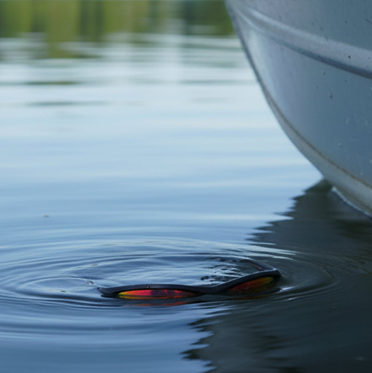 Floating sunglasses in water